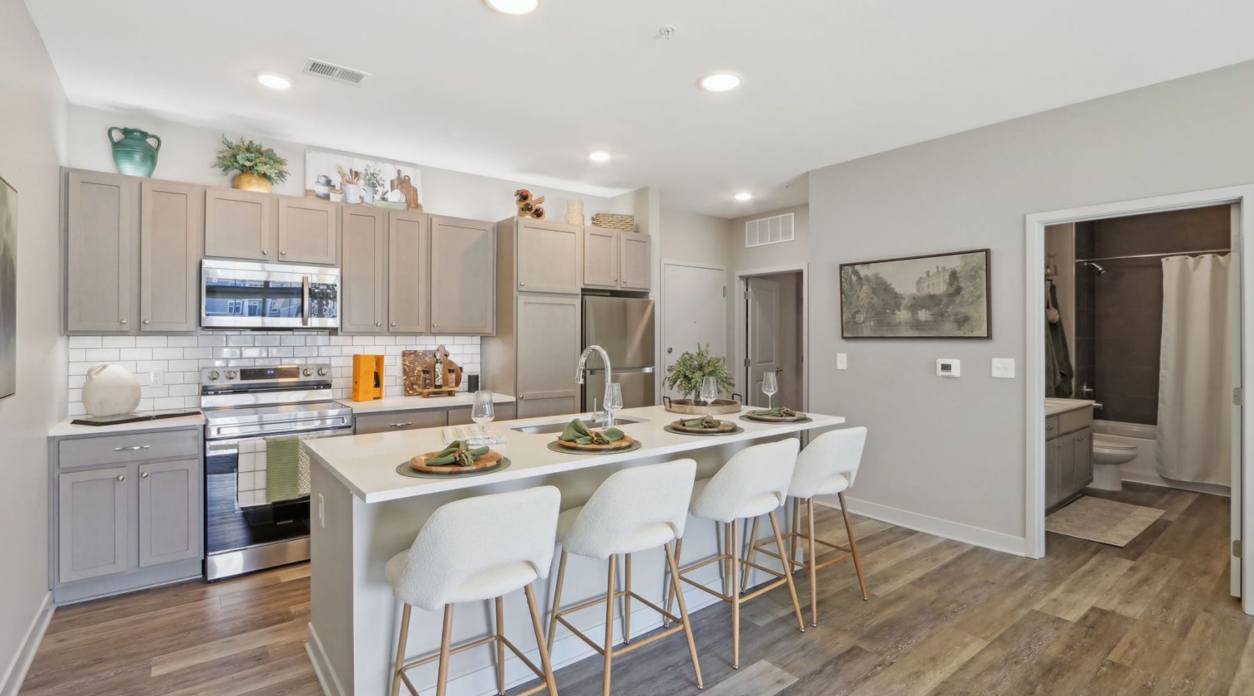 Styled apartment kitchen with island and bar stools