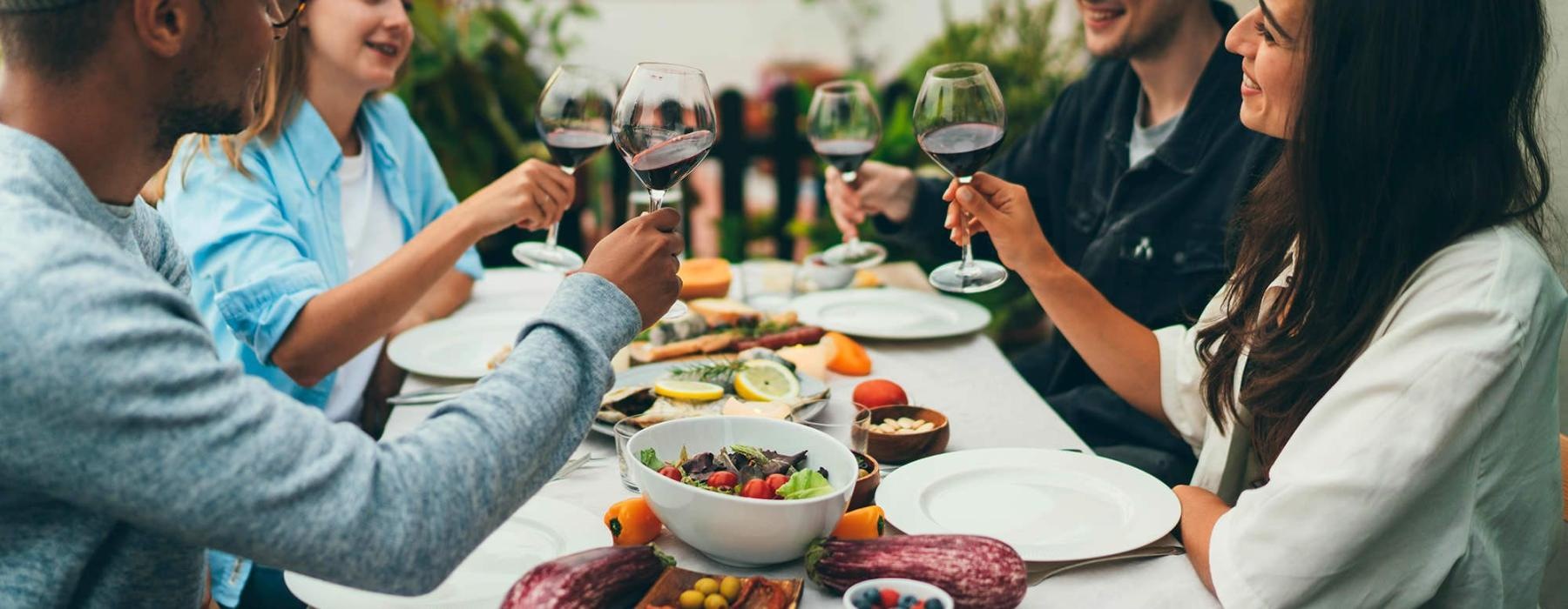 a group of people having a meal around an outdoor table